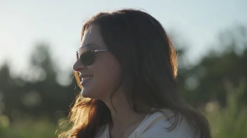 Smiling female face in sun rays smile woman feel happy outside summer relax Stock Footage 138213459