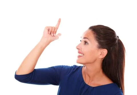 Smiling female with finger pointing up while looking to her right and having  Stock Photos