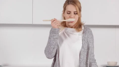 Smiling female holding spoon Stock Footage 154373946