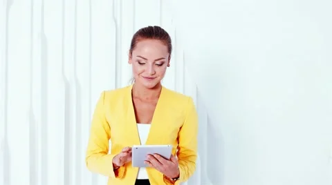 Smiling female model with tablet. The video of modest business woman on white Video stock 61535522