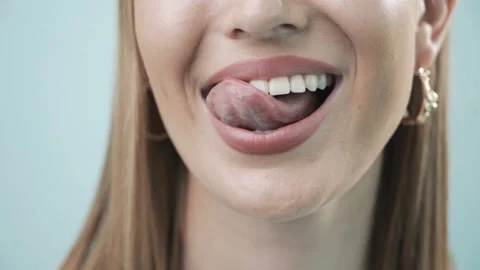 Smiling female mouth licking with tongue... | Stock Video | Pond5