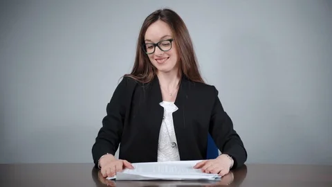 Smiling female office worker checking financial data and receiving stack of Video stock 121336705