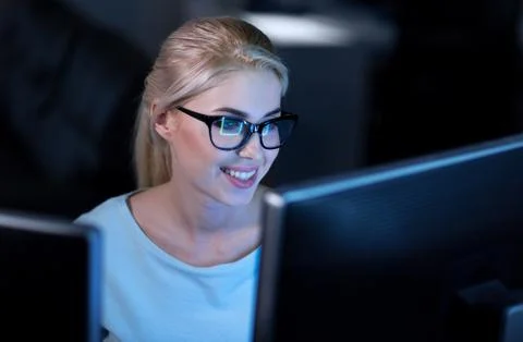 Smiling female programmer decoding codes at work Stock Photos