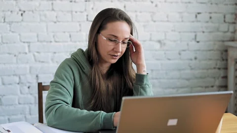 Smiling female student in glasses elearning study with online tutor teacher talk Stock-Footage 153608318