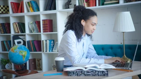 Smiling female student laughing while using video confirence with her teacher Stock Footage 104409388