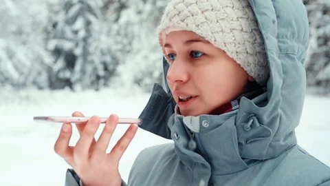 Smiling female studet uses mobile phone to send voice message recognition ai Stock Footage 123074591