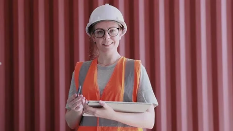 Smiling female warehouse staff using digital tablet working and at shipping  Stock Footage 163640774