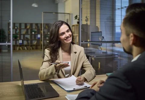 Smiling financial advisor consulting client in modern office on banking options Stock Photos