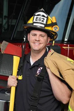 Smiling fireman with equipment close-up Stock Photos