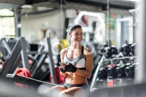 Smiling fit woman listening to music in gym Stock Photos