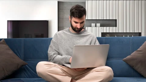 Smiling freelancer man working remotely e learning distance education use laptop Video stock 230847396