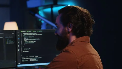 Smiling freelancing developer in home office doing coding on computer Stock Footage 265513568
