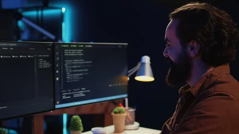 Smiling freelancing developer in home office doing coding on computer Stock Footage 265618713