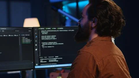 Smiling freelancing developer in home office doing coding on computer 스톡 사진