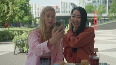 Smiling Friends Having Video Call While Enjoying Outdoor Coffee Break Stock Footage 313844134