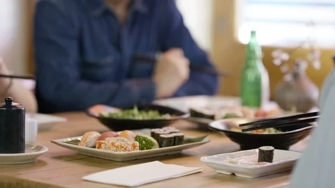 Smiling friends interacting while having meal in restaurant Stock Footage 107974622