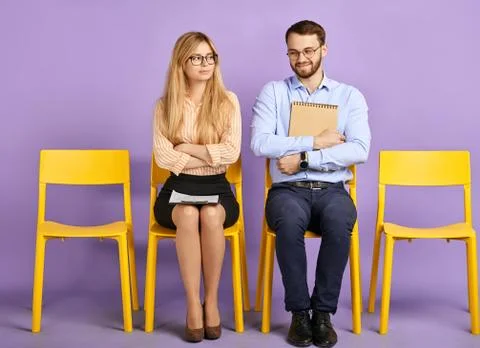 Smiling friends with papers looking in camera Stock Photos