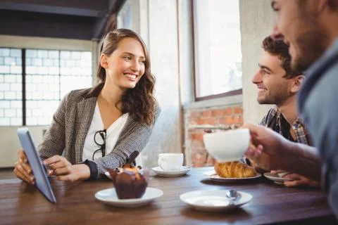 Smiling friends using tablet computer together Stock Photos