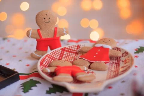 Smiling gingerbread man with lights in background. Stock Photos