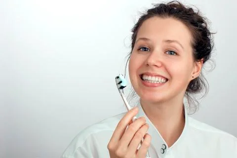 Smiling girl with a green red blue toothbrush Stock Photos