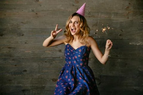 Smiling girl has a fun while celebrating birthday party Stock Photos