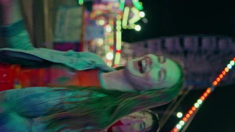 Smiling girl hitting boxing machine game at amusement park vertically oriented Stock Footage 268637396