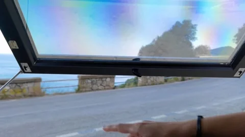 A smiling girl looking at the view from the window Stock Footage 253132522