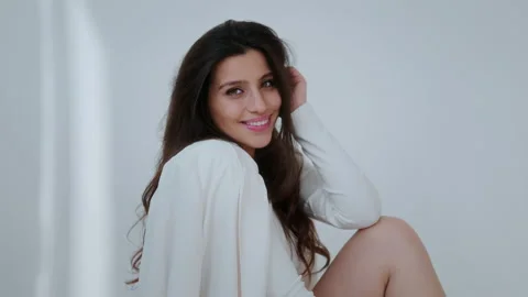 Smiling girl model posing for the camera, model posing in a white studio for a Stock Footage 195829951