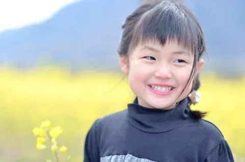Smiling Girl in Mustard Fields Stock Photos