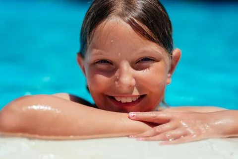 Smiling girl at poolside Stock Photos