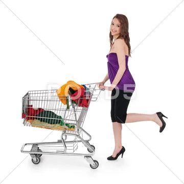 Smiling girl with shopping cart buying colorful clothing Stock Photos