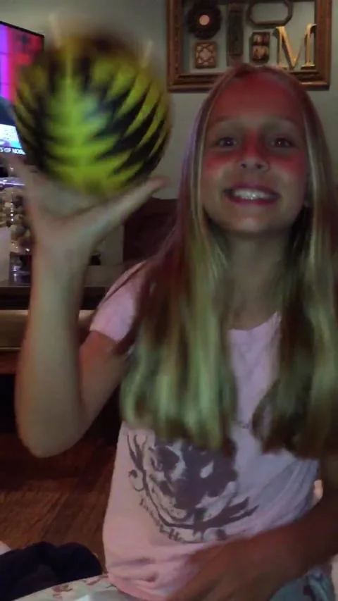 Smiling girl throws ball into camera Stock Footage 304189203