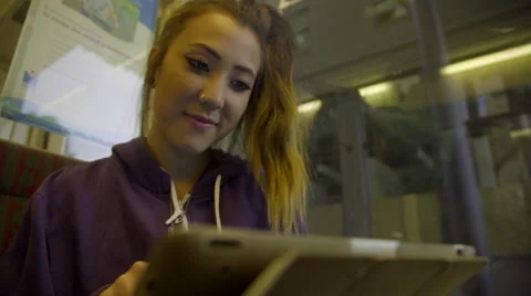Smiling girl uses tablet computer on subway Stock Footage 54099091
