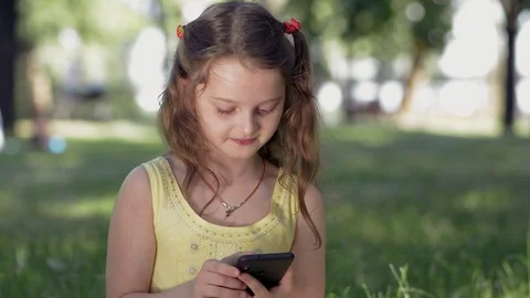 Smiling girl using smartphone Stock Footage 109073064
