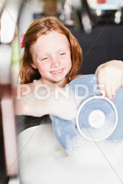 Smiling Girl Washing Plate In Sink