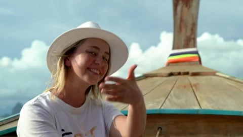 Smiling girl in white hat on excursion sails in Thai boat Stock Footage 309827581