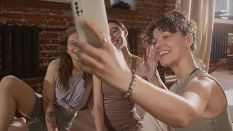 Smiling Girlfriends Taking Selfie Together on Smartphone after Yoga Class Stock Footage 329742901