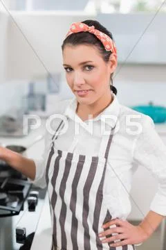 Smiling gorgeous cook posing Stock Photos