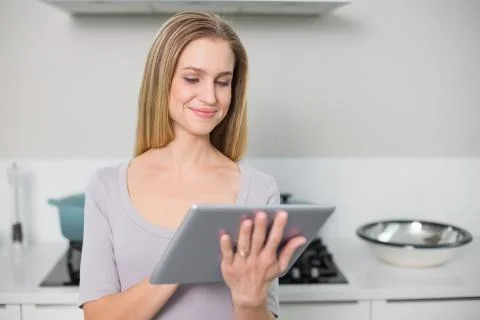 Smiling gorgeous model using tablet Stock Photos