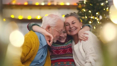 Smiling grandparents and grandson sitting on couch at home Stock Footage