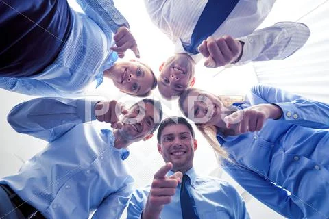 Smiling group of businesspeople standing in circle Stock Photos