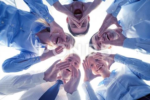 Smiling group of businesspeople standing in circle Stock Photos