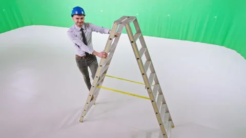 Smiling guy engineer posing in front of the camera while standing on the ladder Stock Footage 138889680