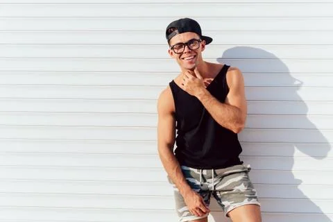 Smiling guy posing at camera, outdoors. Stock Photos