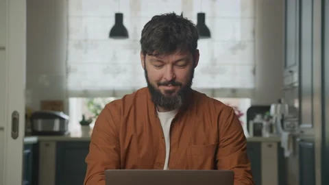 Smiling guy studying on a computer laptop Stockbeeldmateriaal 199305689