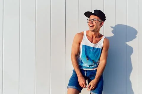 Smiling guy in stylish clothes posing outdoors. Stock Photos