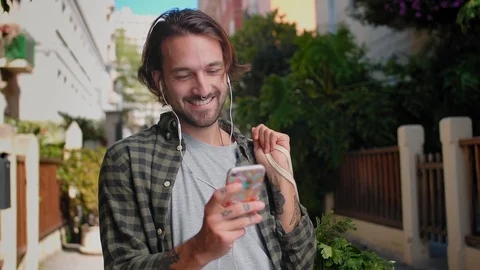 Smiling guy using Instagram swiping photos of friend and laughing of internet Stock Footage 111071578