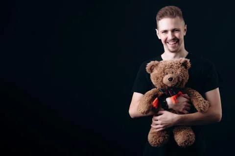 Smiling Handsome Guy Hugging a Teddy Bear Stock Photos