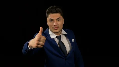 Smiling handsome guy making thumbs up gesture Stock Footage 74677967