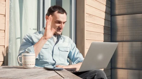 Smiling handsome man having facetime video call talking to his family Stock Footage 128946200